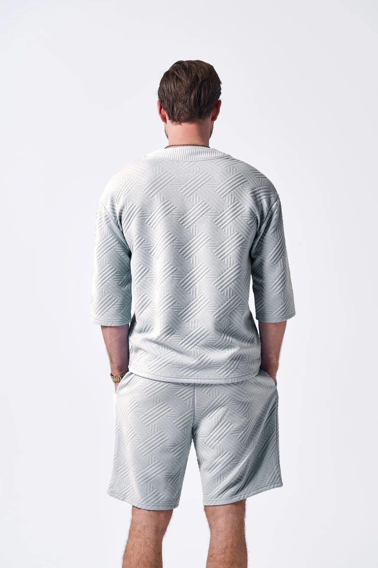 The 2025 new men's summer suit is a casual and versatile solid-color jacquard V-neck short-sleeved T-shirt with two shorts