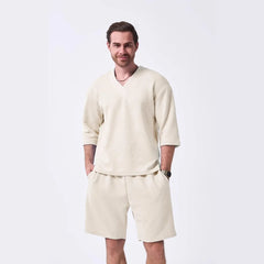 The 2025 new men's summer suit is a casual and versatile solid-color jacquard V-neck short-sleeved T-shirt with two shorts